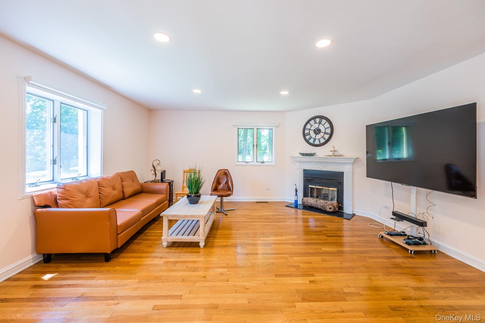 530 South Centre Island Road Centre Island, NY 11771 - Photo 11 of 32 Living area featuring light wood finished floors, recessed lighting, and a glass covered fireplace