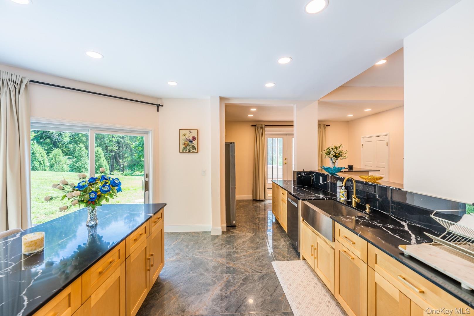 530 South Centre Island Road Centre Island, NY 11771 - Photo 12 of 32 Kitchen featuring dark stone countertops, recessed lighting, light brown cabinetry, and appliances with stainless steel finishes