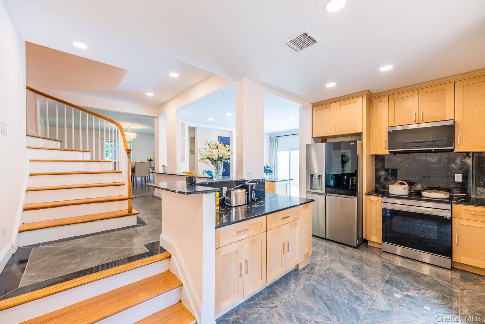 530 South Centre Island Road Centre Island, NY 11771 - Photo 14 of 32 Kitchen with light brown cabinets, dark stone countertops, appliances with stainless steel finishes, dark marble finish flooring, and recessed lighting