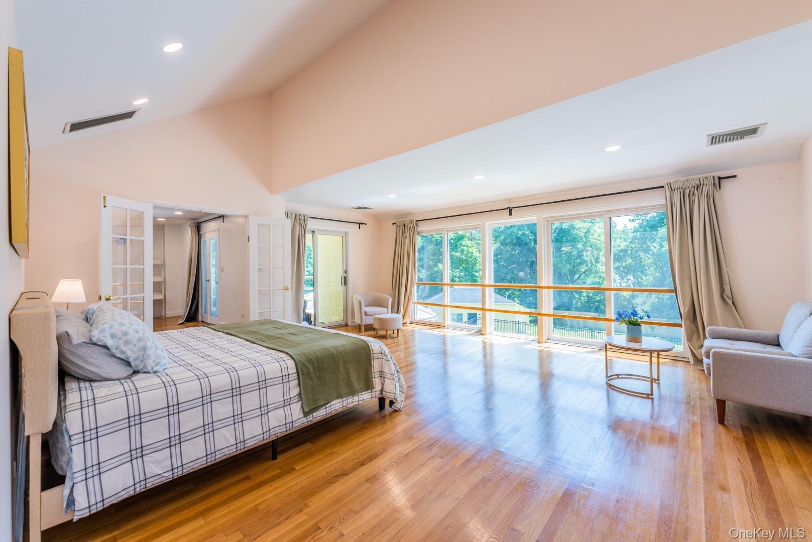 530 South Centre Island Road Centre Island, NY 11771 - Photo 17 of 32 Bedroom featuring wood finished floors, recessed lighting, access to exterior, and high vaulted ceiling