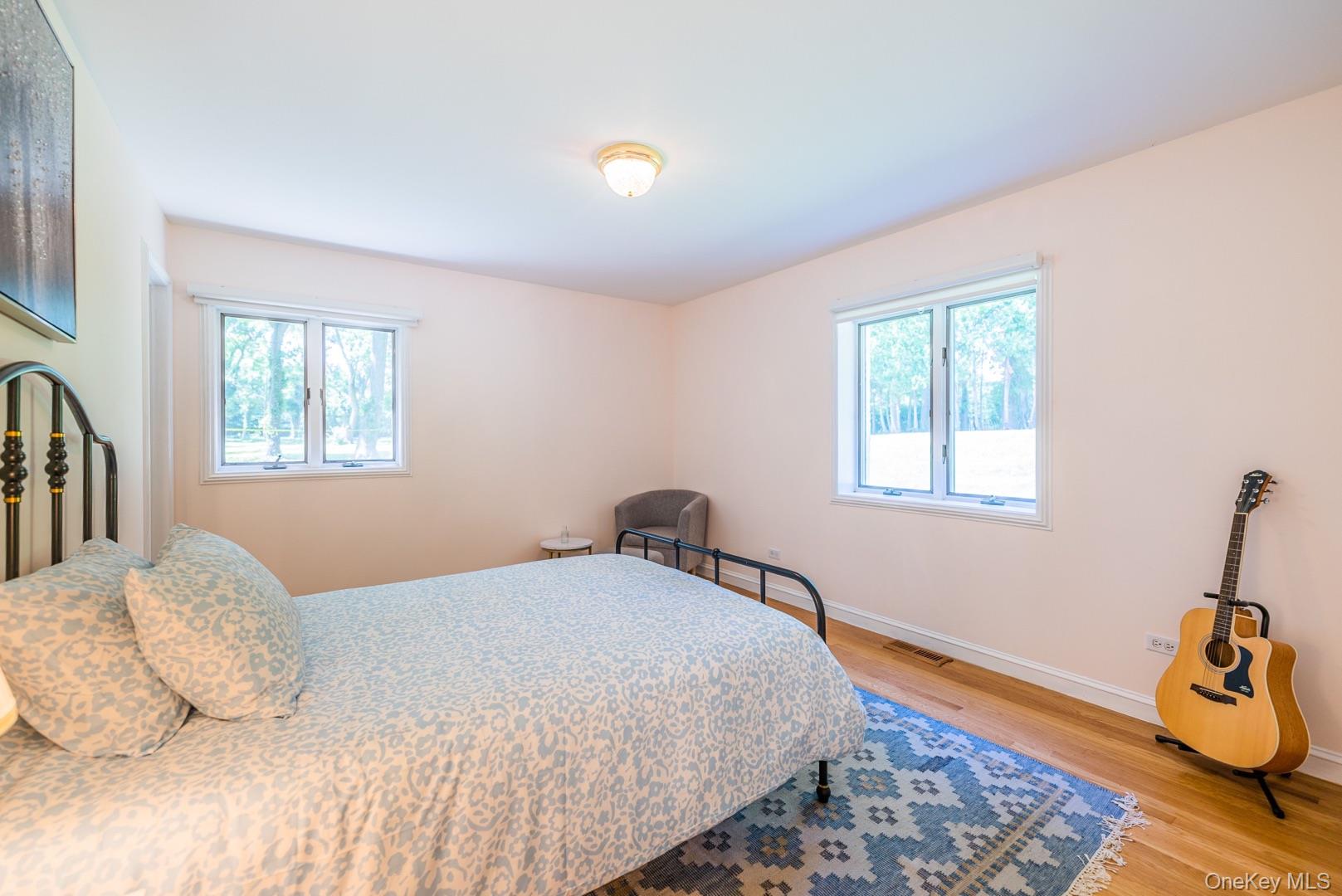530 South Centre Island Road Centre Island, NY 11771 - Photo 22 of 32 Bedroom featuring light wood finished floors and multiple windows