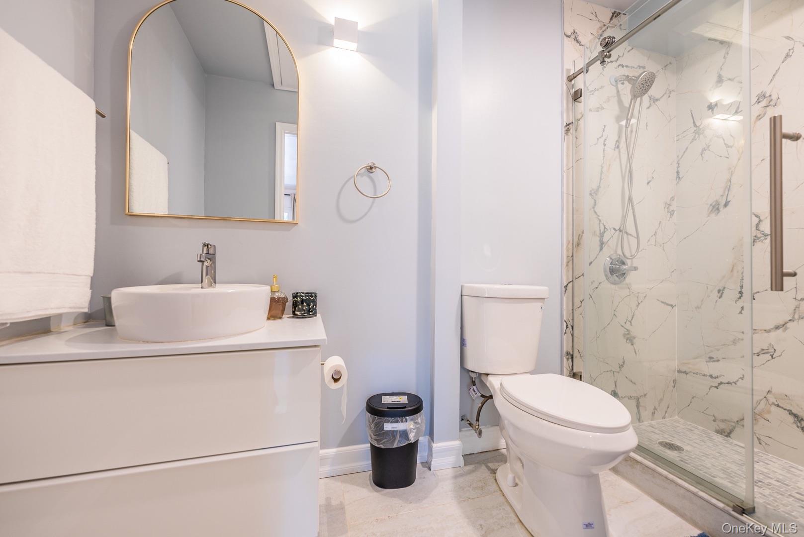 530 South Centre Island Road Centre Island, NY 11771 - Photo 23 of 32 Bathroom featuring a marble finish shower, vanity, and light tile patterned flooring