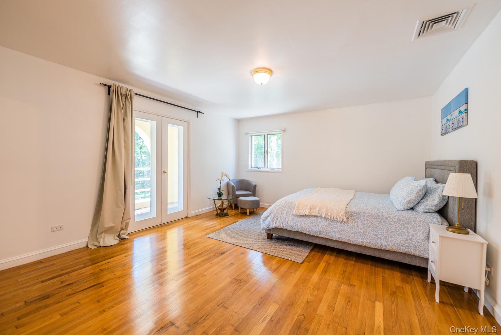 530 South Centre Island Road Centre Island, NY 11771 - Photo 25 of 32 Bedroom featuring light wood-type flooring and access to exterior