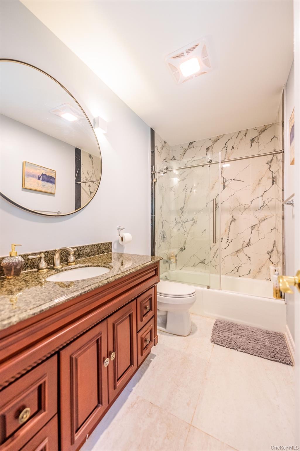 530 South Centre Island Road Centre Island, NY 11771 - Photo 26 of 32 Bathroom with enclosed tub / shower combo, vanity, and light tile patterned floors