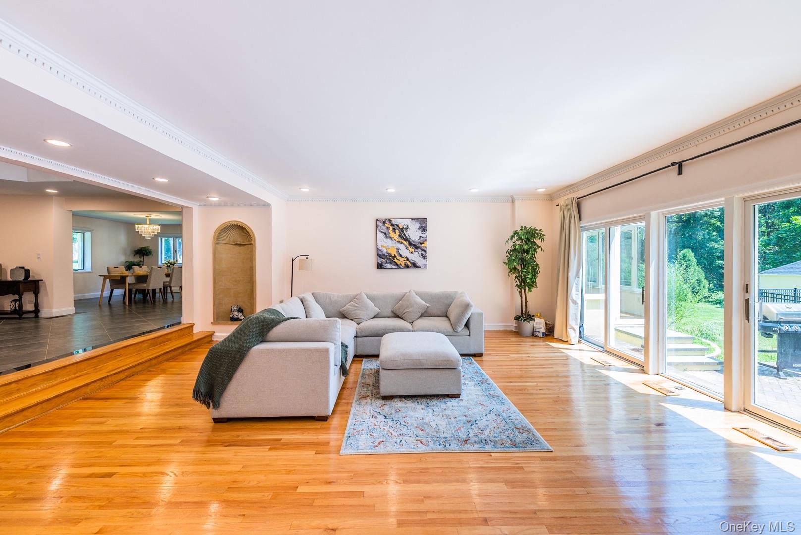 530 South Centre Island Road Centre Island, NY 11771 - Photo 10 of 32 Living room featuring healthy amount of natural light, light wood-type flooring, crown molding, and recessed lighting