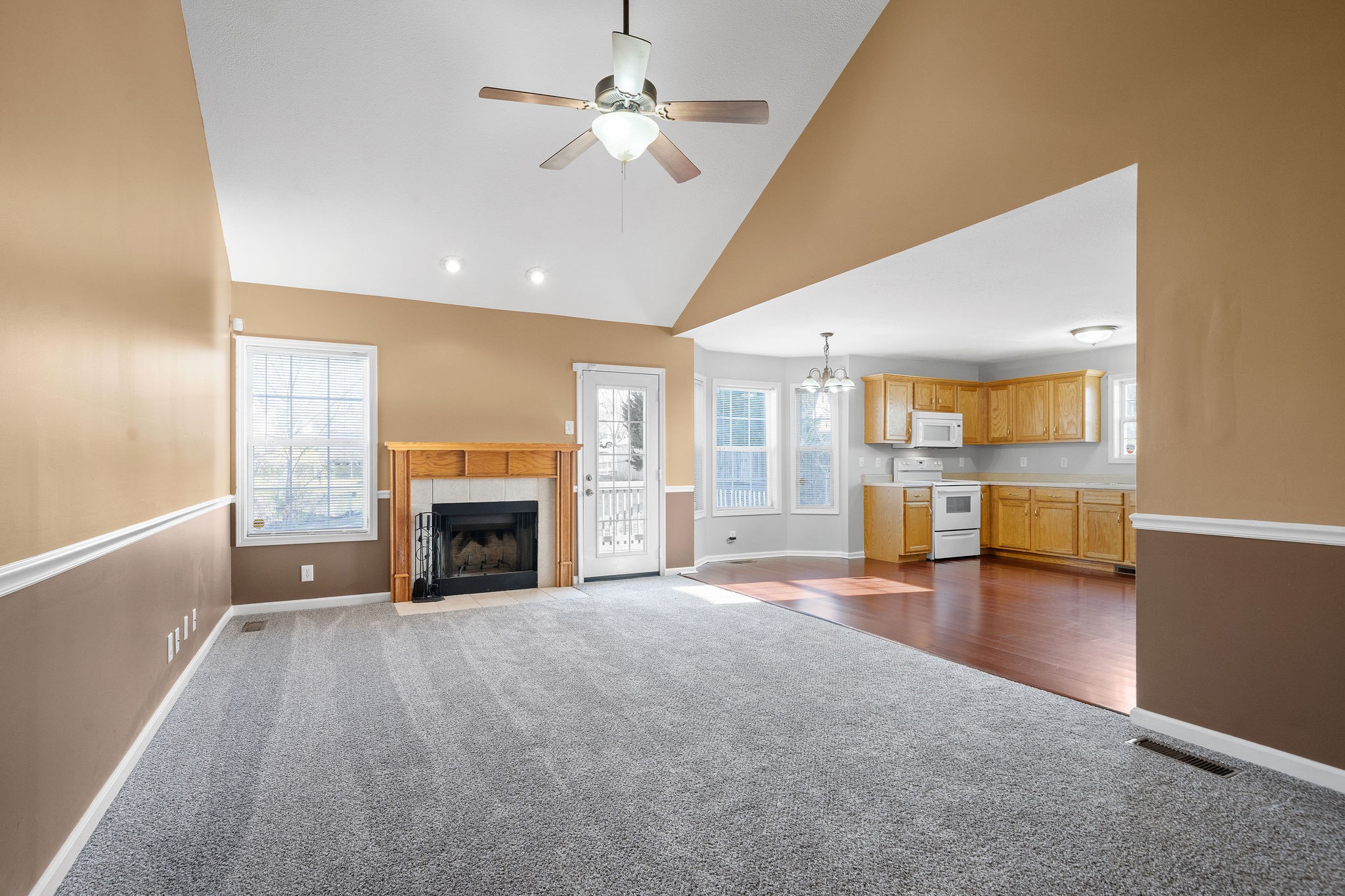 2904 Core Drive Clarksville, TN 37040 - Photo 6 of 23 a view of a livingroom with a fireplace a ceiling fan and windows