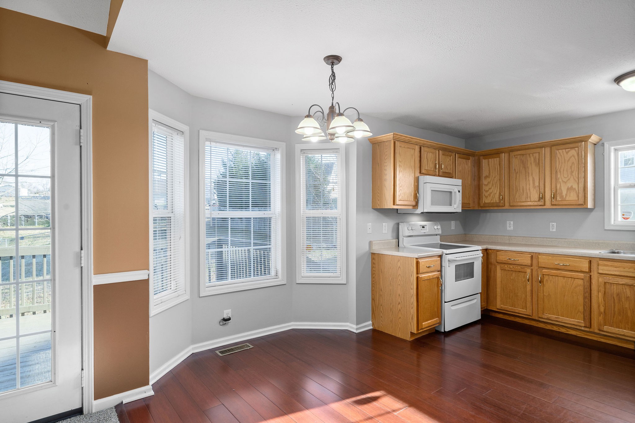 2904 Core Drive Clarksville, TN 37040 - Photo 8 of 23 a kitchen with stainless steel appliances granite countertop a stove a sink and white cabinets with wooden floor
