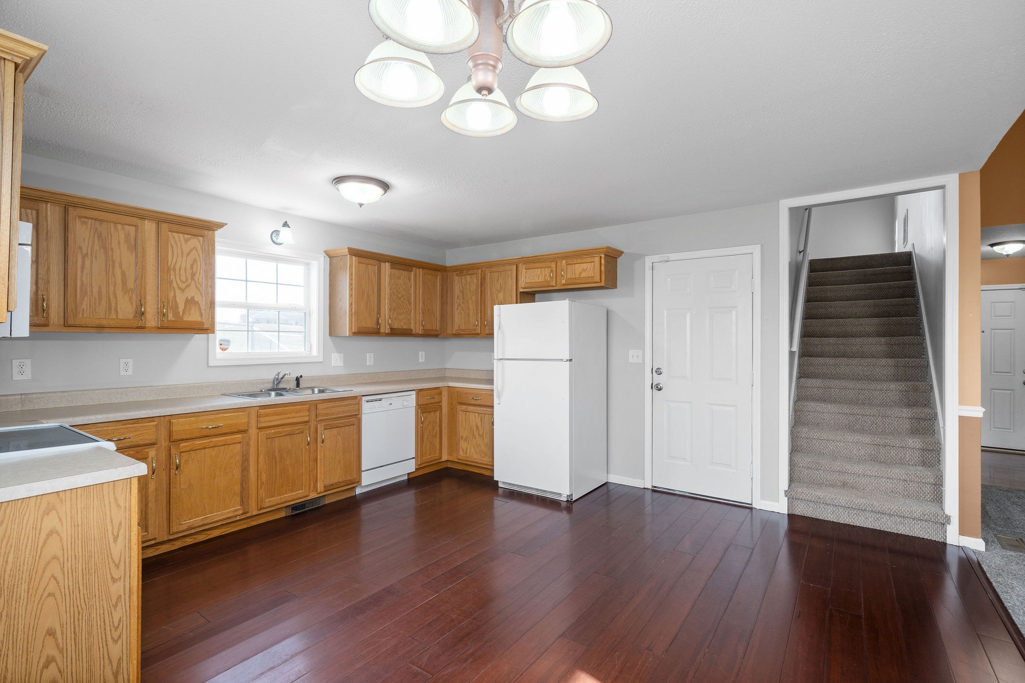2904 Core Drive Clarksville, TN 37040 - Photo 9 of 23 a large kitchen with stainless steel appliances granite countertop a dishwasher a stove a sink dishwasher and a oven with wooden floors