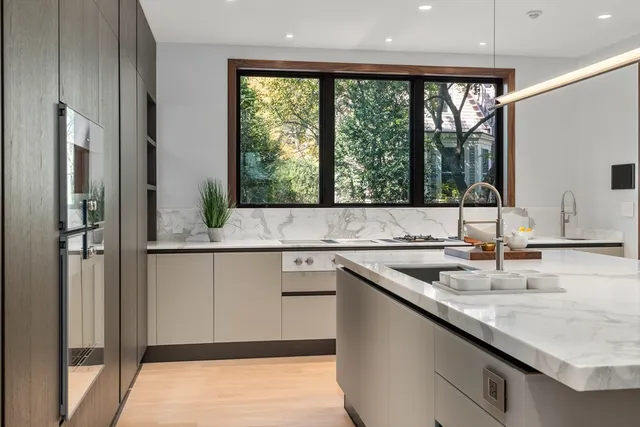 a kitchen with a sink window and cabinets