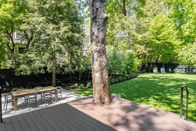 a view of backyard of house with outdoor seating and green space