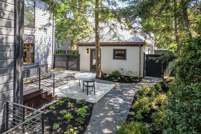 an aerial view of a house with swimming pool and garden