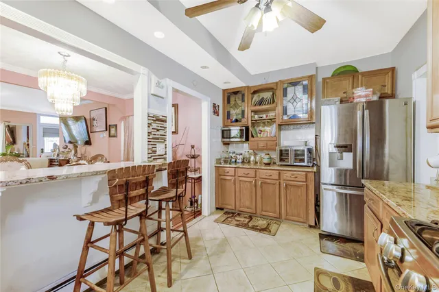 a kitchen with a stove a sink and white cabinets
