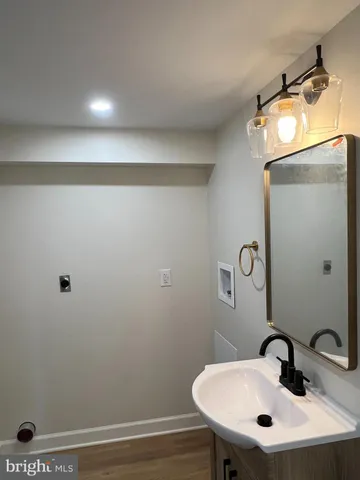 a bathroom with a sink a mirror and vanity