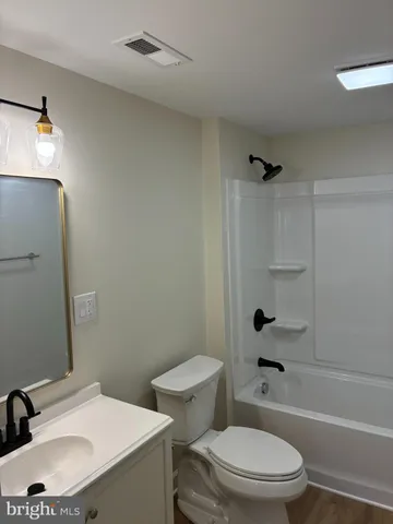a white toilet sitting next to a bathroom sink and shower