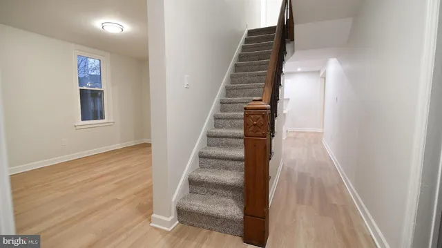 a view of a hallway with wooden floor and entryway