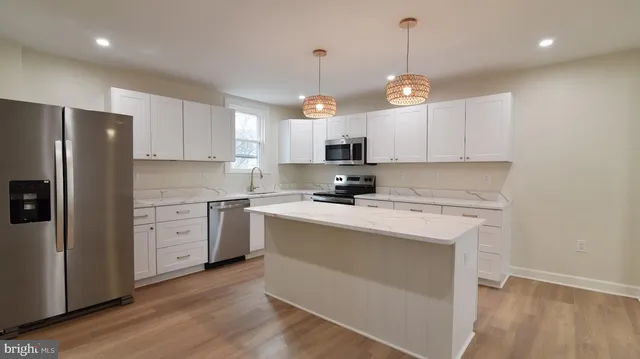 a kitchen with stove cabinets and refrigerator