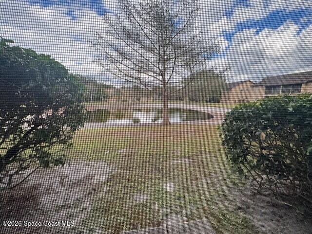 240 Spring Drive, Unit 5 Merritt Island, FL 32953 - Photo 2 of 17 a view of house with yard