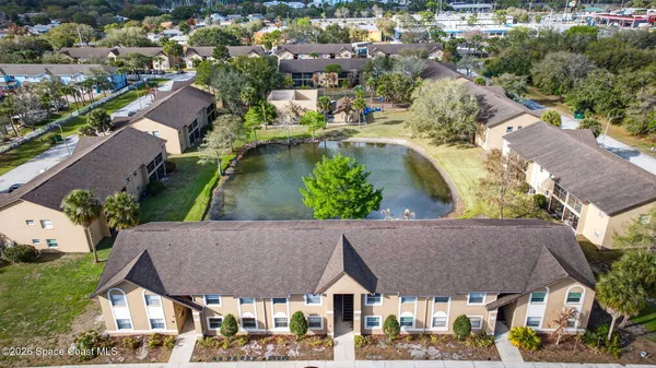 an aerial view of residential houses with outdoor space and swimming pool