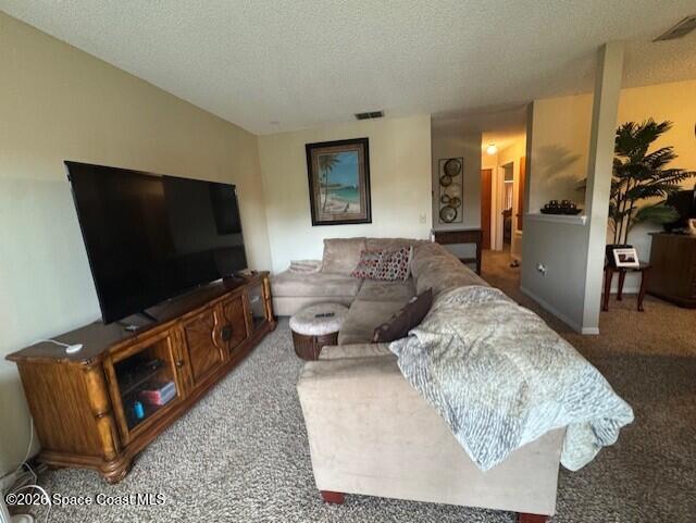 240 Spring Drive, Unit 5 Merritt Island, FL 32953 - Photo 8 of 17 a living room with furniture and a flat screen tv