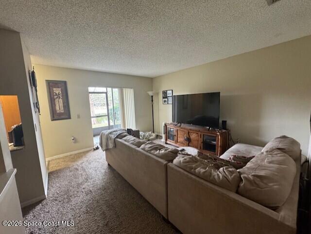 240 Spring Drive, Unit 5 Merritt Island, FL 32953 - Photo 9 of 17 a living room with furniture and a flat screen tv
