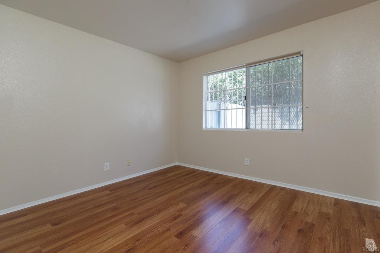 468 West Wooley Road Oxnard, CA 93030 - Photo 11 of 16 an empty room with wooden floor and windows