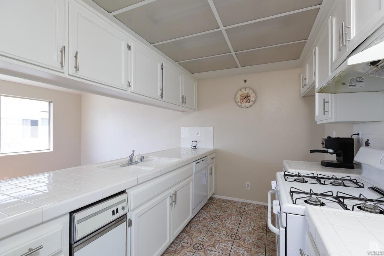 468 West Wooley Road Oxnard, CA 93030 - Photo 12 of 16 a kitchen with cabinets appliances and a window
