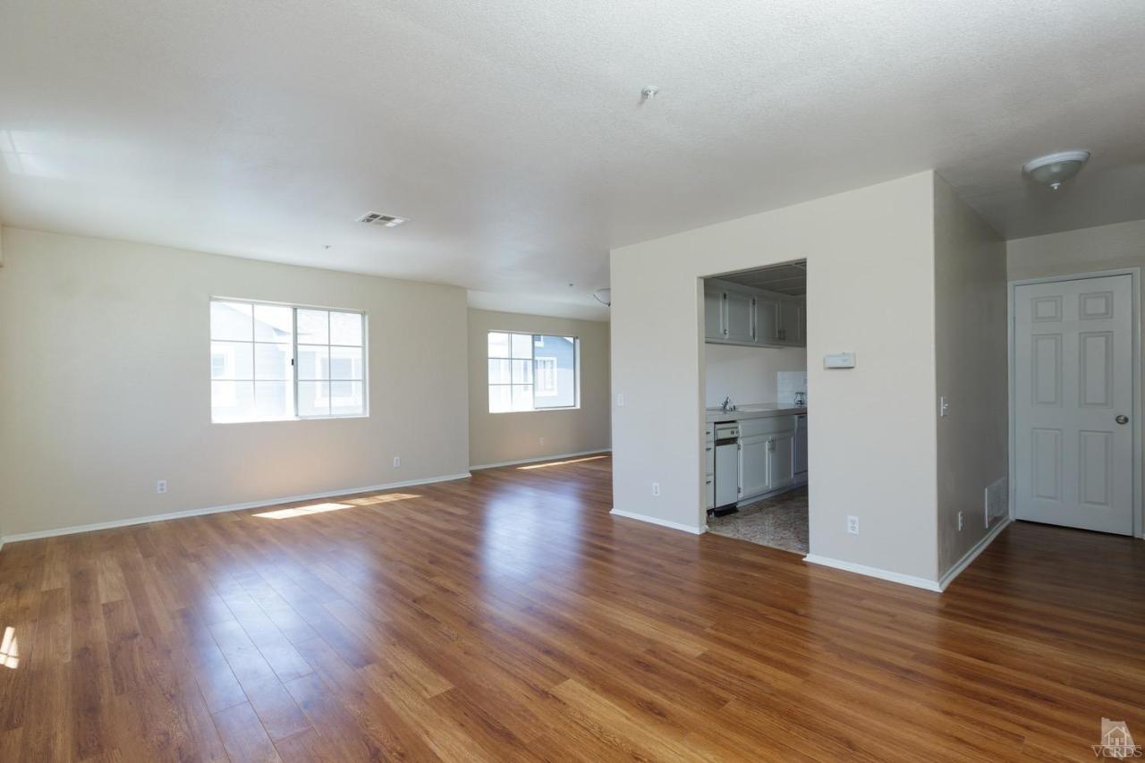 468 West Wooley Road Oxnard, CA 93030 - Photo 3 of 16 an empty room with wooden floor and windows
