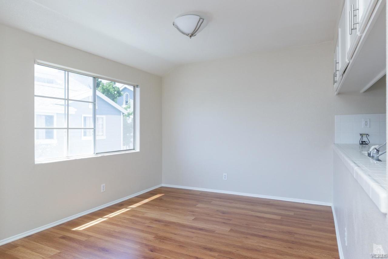 468 West Wooley Road Oxnard, CA 93030 - Photo 5 of 16 an empty room with wooden floor and windows