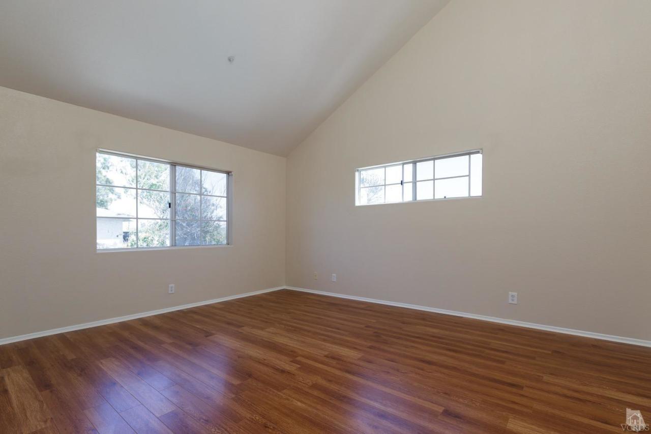 468 West Wooley Road Oxnard, CA 93030 - Photo 6 of 16 an empty room with wooden floor and windows