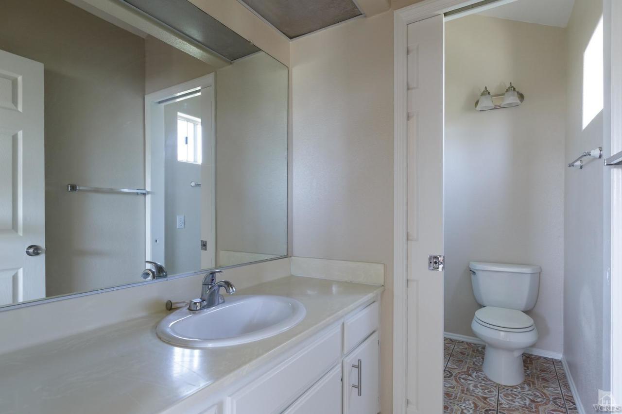 468 West Wooley Road Oxnard, CA 93030 - Photo 7 of 16 a bathroom with a granite countertop sink toilet and shower