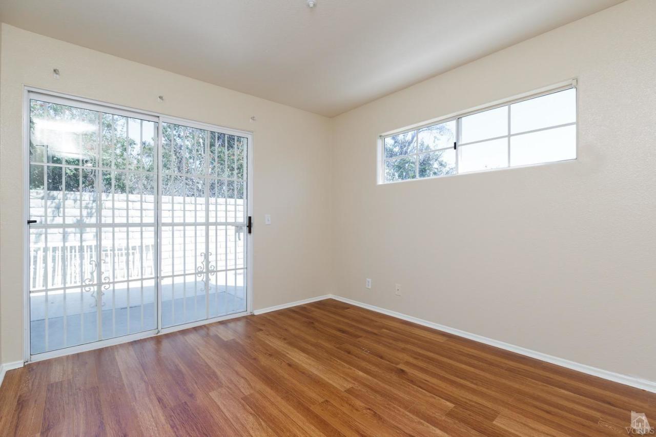 468 West Wooley Road Oxnard, CA 93030 - Photo 8 of 16 an empty room with wooden floor and windows