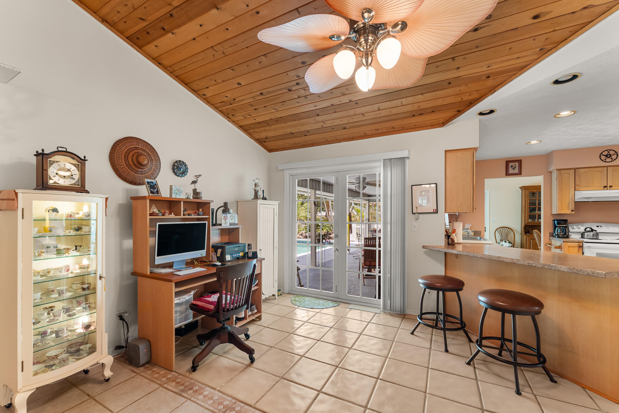 1653 Southwest 85th Terrace Stuart, FL 34997 - Photo 20 of 54 a room with furniture a clock and a flat screen tv