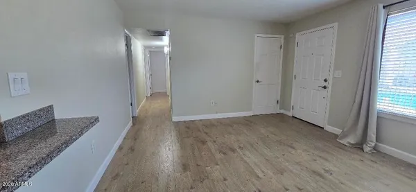 a view of hallway with wooden floor