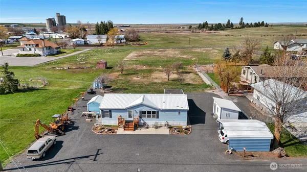 an aerial view of residential houses with outdoor space and lake view