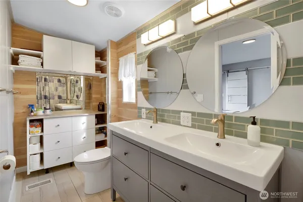 a bathroom with a sink double vanity and a mirror