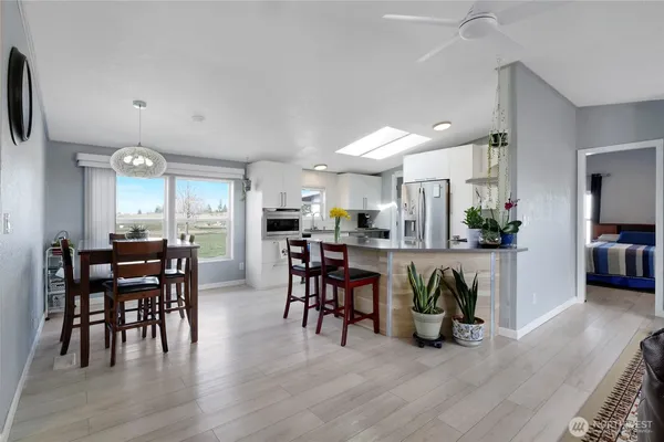 a dining room with furniture and wooden floor