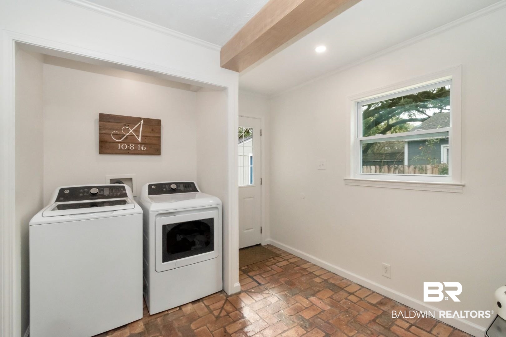 113 Ellinor Street Mobile, AL 36606 - Photo 22 of 28 Clothes washing area with baseboards, laundry area, brick floor, ornamental molding, and washer and dryer