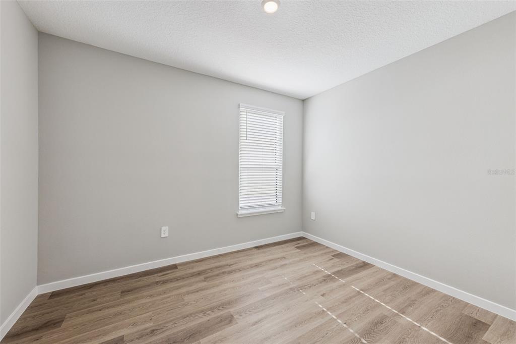 544 North Bumby Avenue, Unit 5 Orlando, FL 32803 - Photo 14 of 26 an empty room with wooden floor and window
