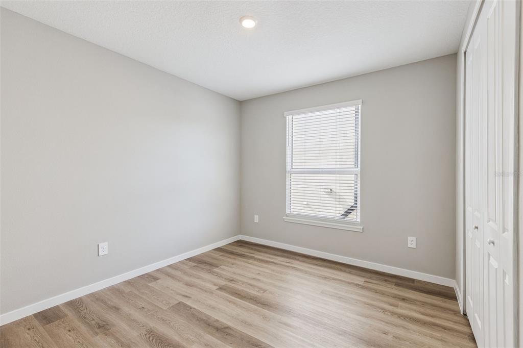 544 North Bumby Avenue, Unit 5 Orlando, FL 32803 - Photo 16 of 26 an empty room with wooden floor and windows