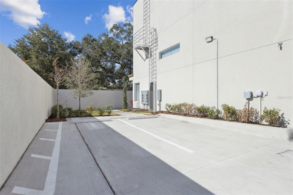 544 North Bumby Avenue, Unit 5 Orlando, FL 32803 - Photo 20 of 26 a house with a yard and a large parking space