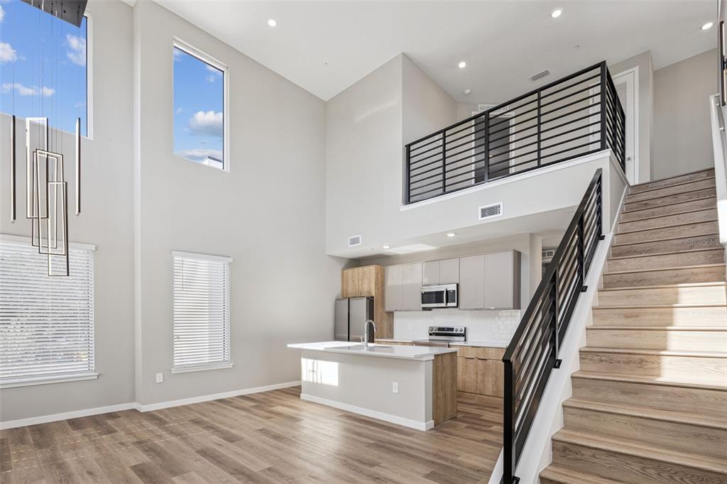 544 North Bumby Avenue, Unit 5 Orlando, FL 32803 - Photo 6 of 26 a view of staircase and kitchen with wooden floor