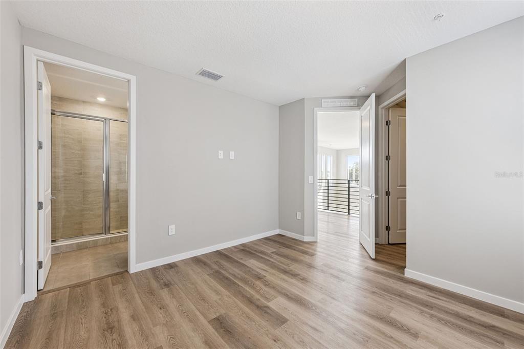 544 North Bumby Avenue, Unit 5 Orlando, FL 32803 - Photo 10 of 26 a view of an empty room with wooden floor and a window