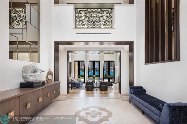 a view of a dining room with furniture large windows and wooden floor