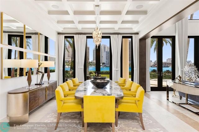 a kitchen with a table chairs sink and cabinets