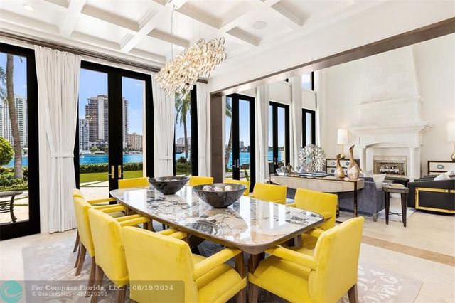 a kitchen with a table chairs sink and cabinets