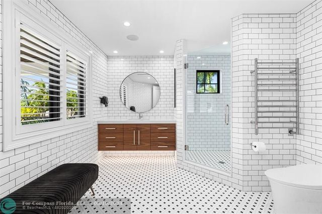 an aerial view of a house with a garden and lake view