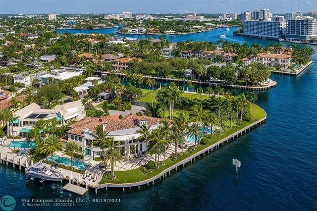 a living room with fireplace furniture and large windows