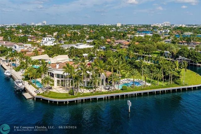 a living room with fireplace furniture and a large window