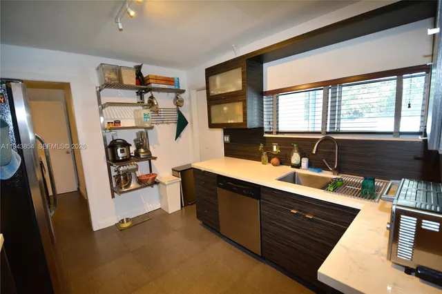 a bed sitting in a spacious bedroom next to a window