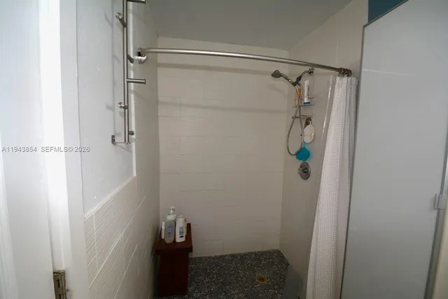 a view of a patio with table and chairs potted plants and a large tree